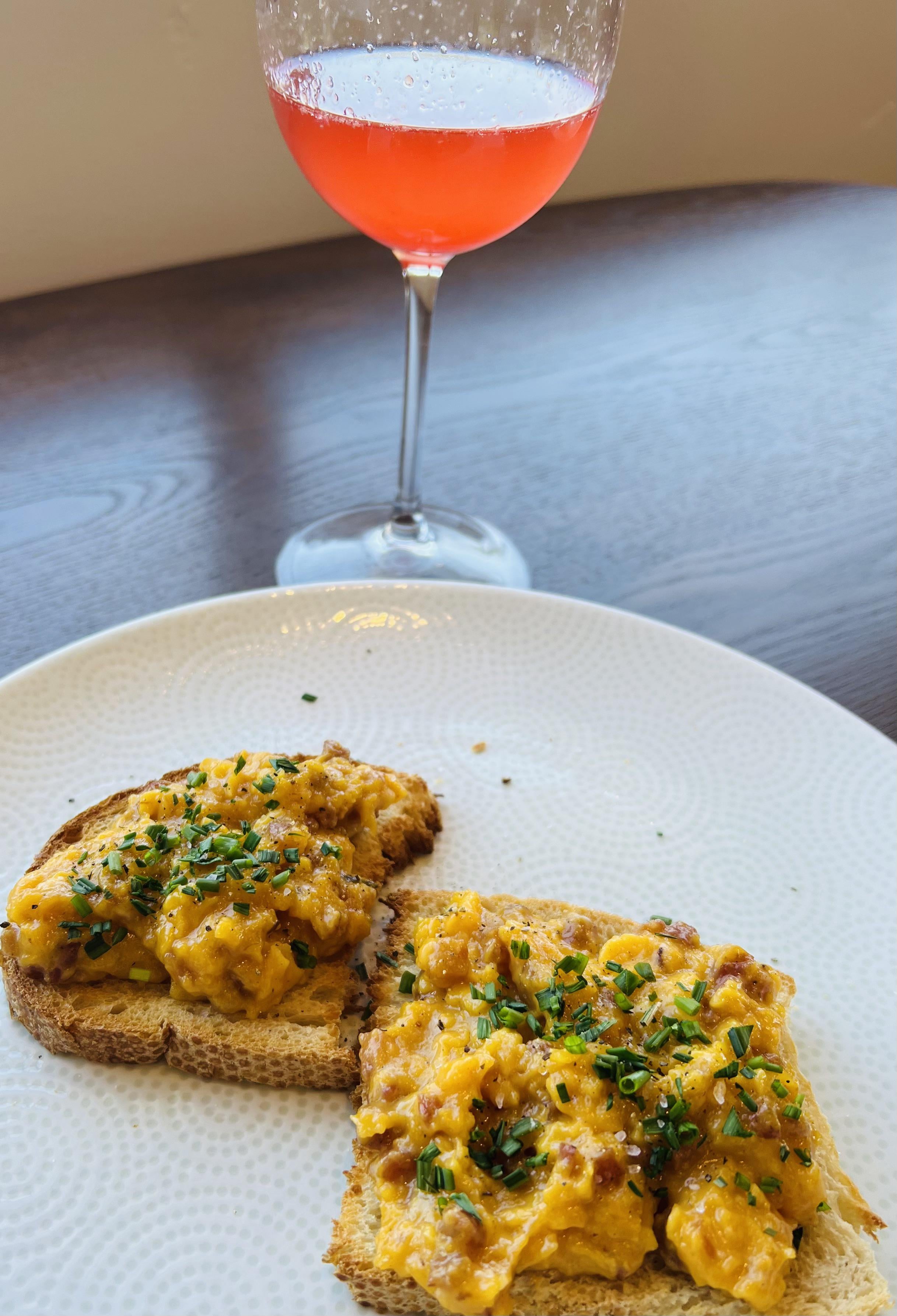Pancetta scrambled eggs on sourdough toast with blood orange mimosa