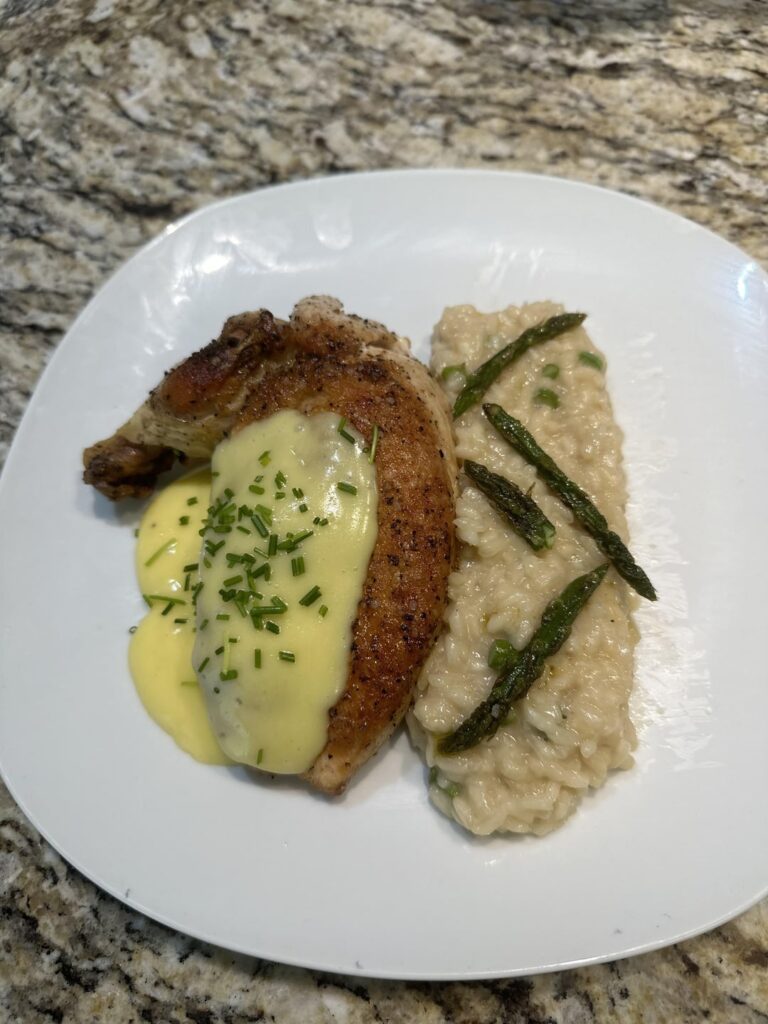 Chicken supremé with a hollandaise sauce served with asparagus risotto