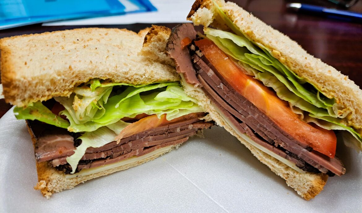 Simple roast beef on wheat with Swiss, lettuce, tomato and Mr. Mustard