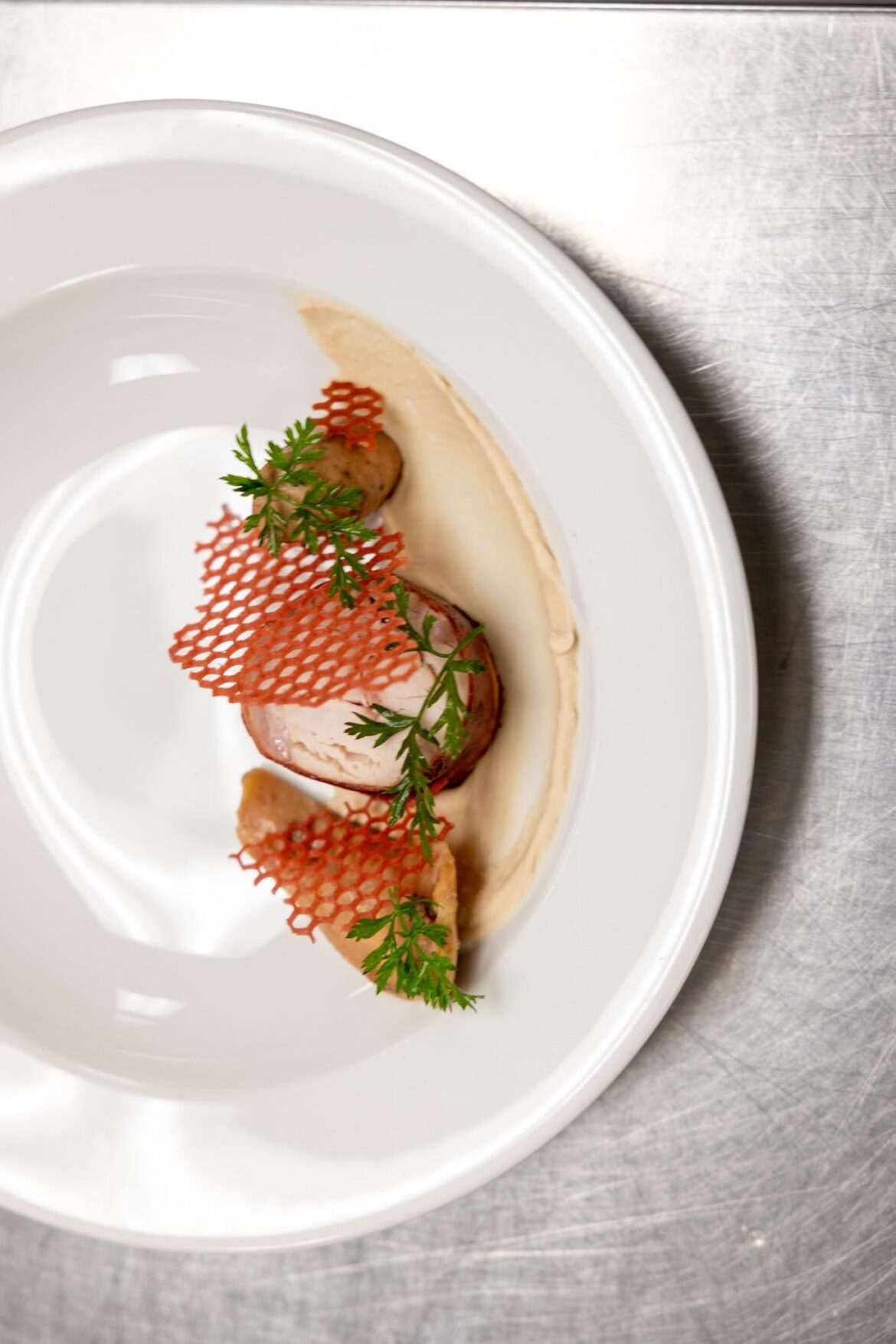 Prosciutto wrapped rabbit saddle, rabbit sausage, carrot textures