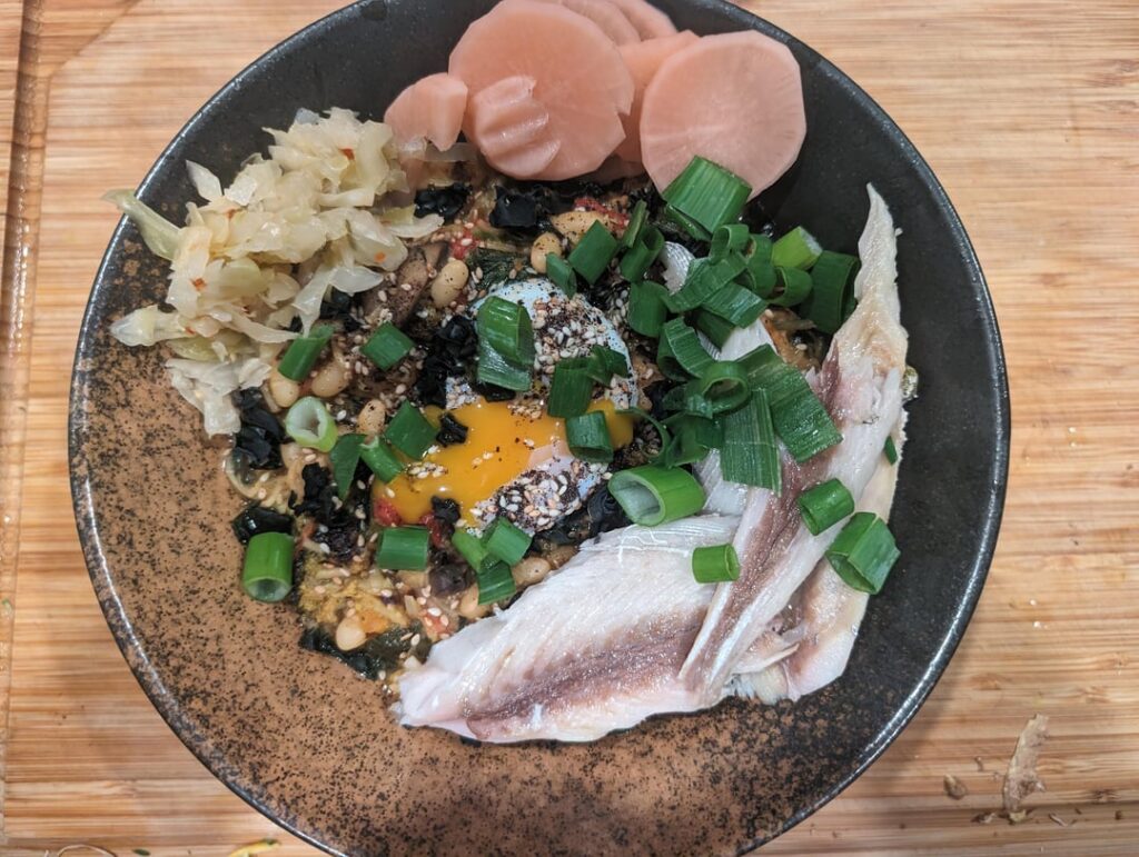 Extreme veggie ramen with sous vide egg yolk, kimchi, pickled daikon and Spanish mackerel.
