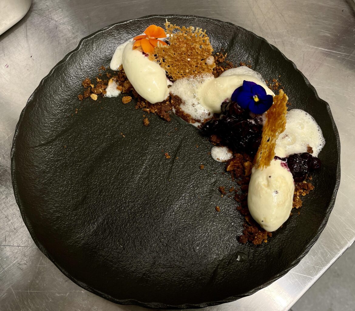 Goat cheese ice cream, almond crumble, smoked blueberry ragu, goat cheese cracker and honey foam