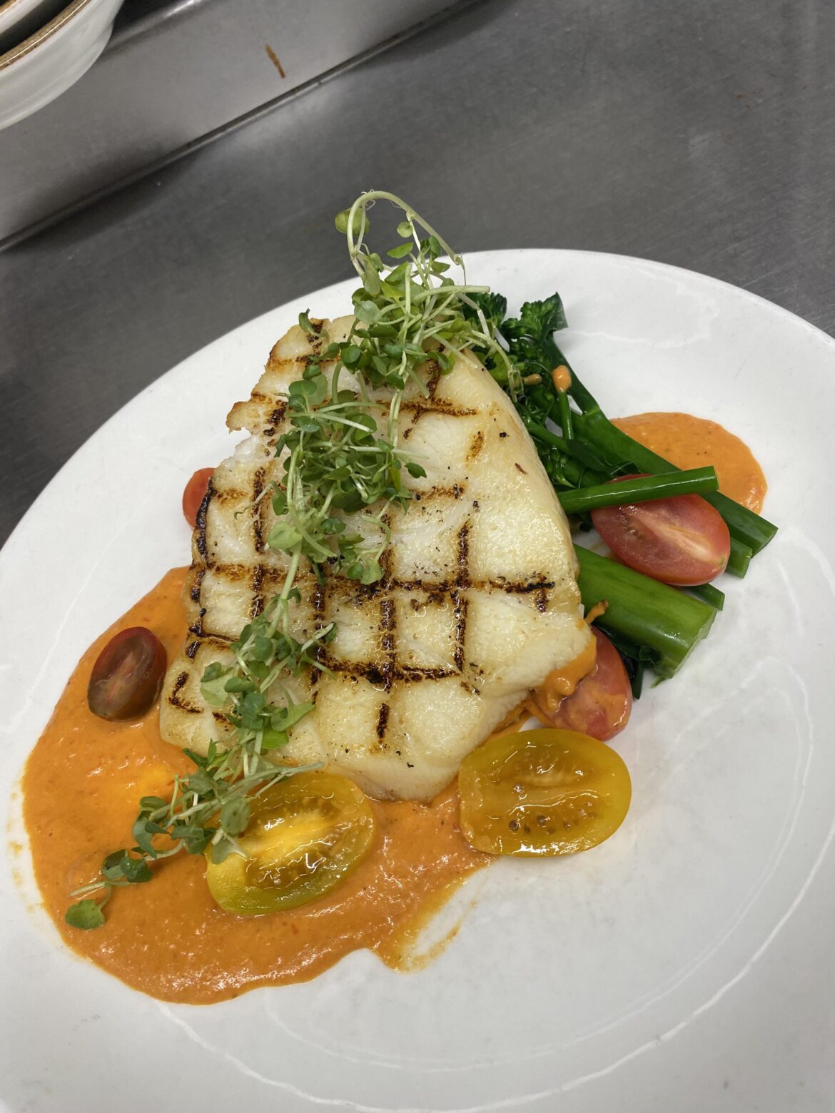 Roasted red pepper vodka sauce, Chilean sea bass, broccolini and cherry tomatoes
