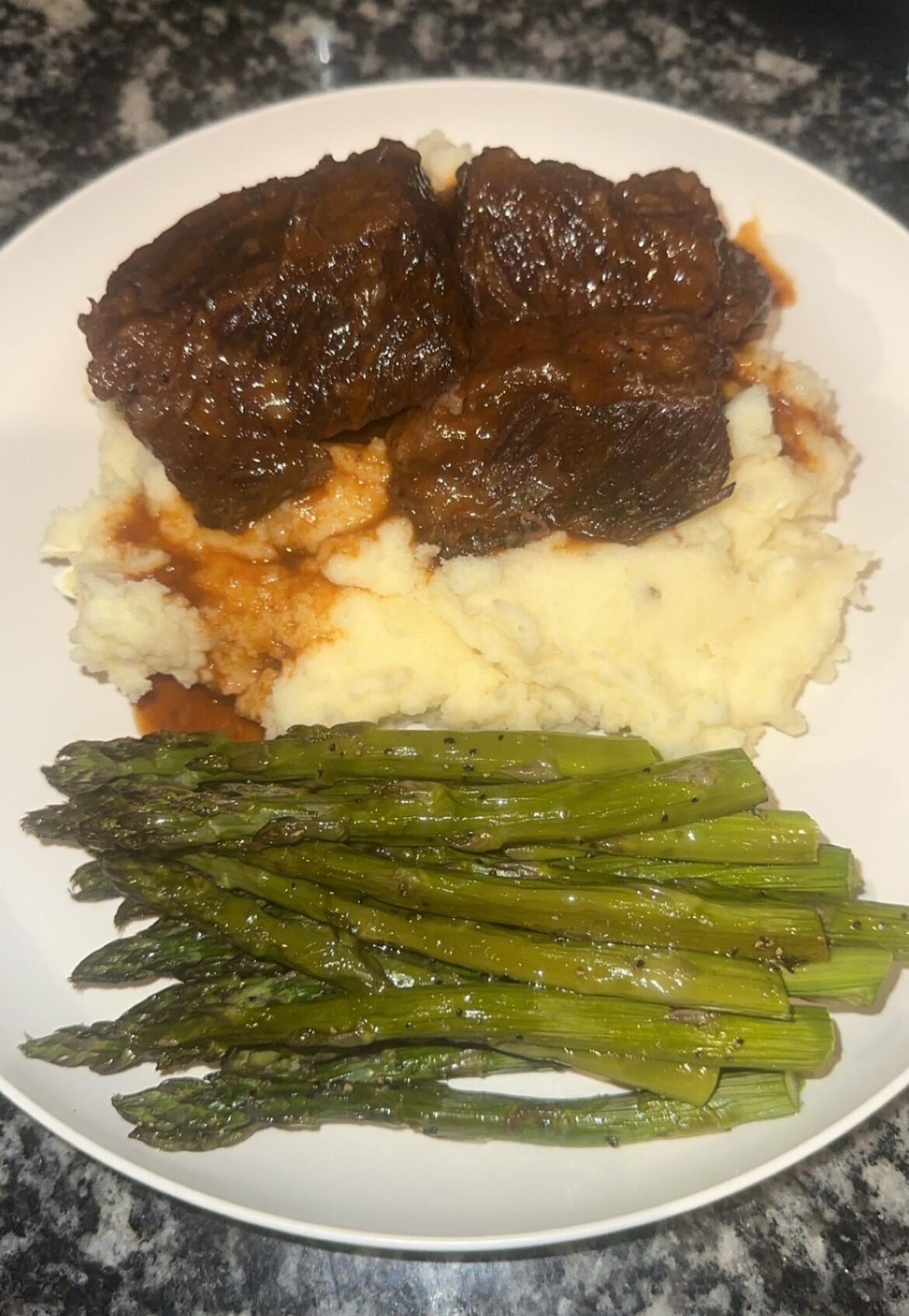 Red Wine Braised Short Ribs over Creamy Garlic Infused Mashed Potatoes and Roasted Asparagus