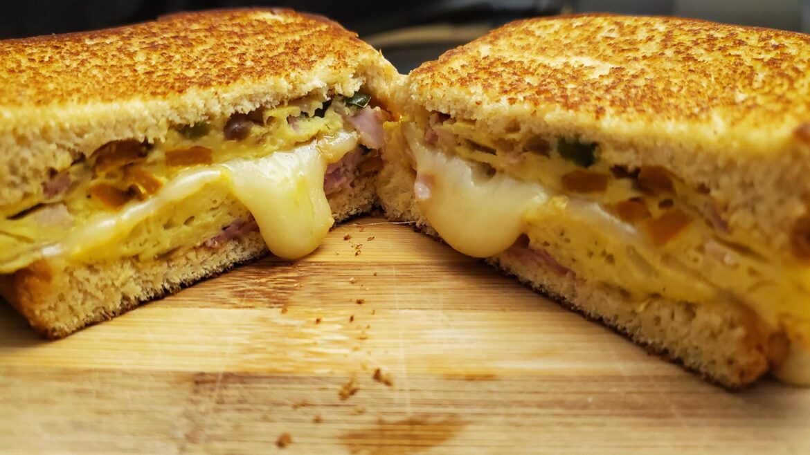 I made a Western egg omelette sandwich with American cheese on potato bread.