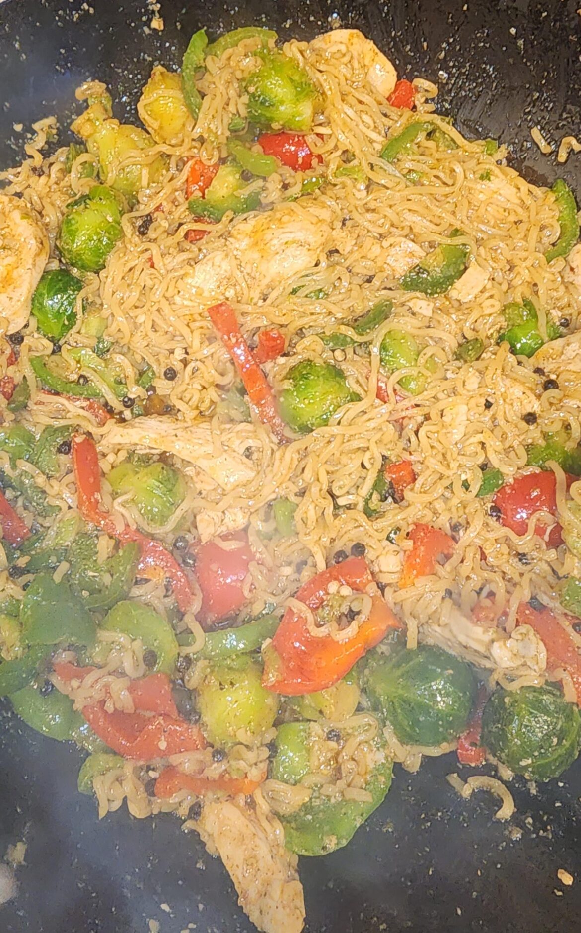 Follow up: How I usually do spicy ramen. Yes, those black bits are whole pepper corns. Yes, I'm frying pre-prepared ramen in a wok.