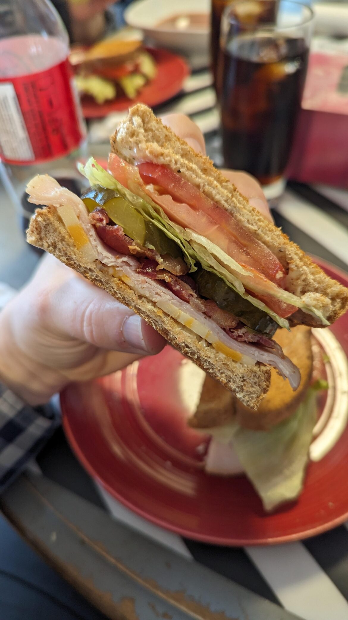 Cheese, deli turkey, bacon, spicy pickles, lettuce, tomato on toasted whole wheat with a bit of mayo.