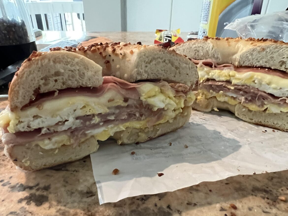 Fried mortadella with two fried eggs and American cheese on a NYC onion bagel (homemade)