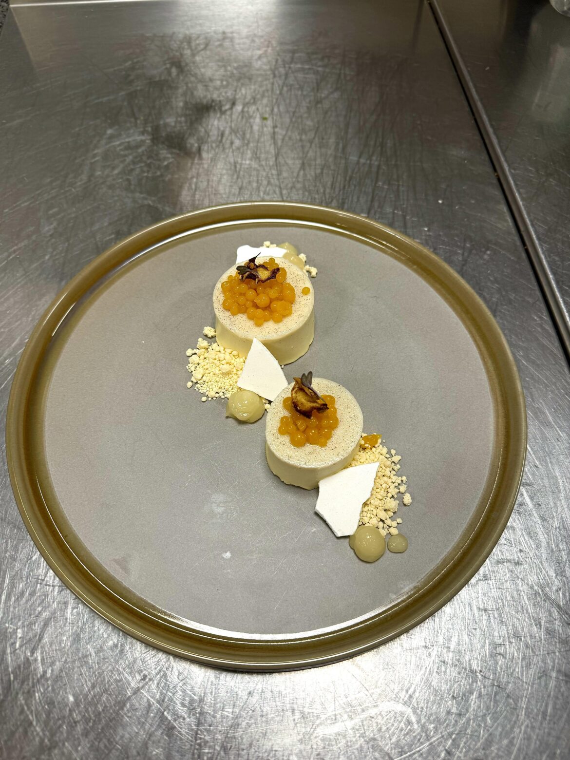 Quick staff dessert: Ginger lemongrass Panna Cotta, yuzu gel, W.C. soil, mango caviar, meringue