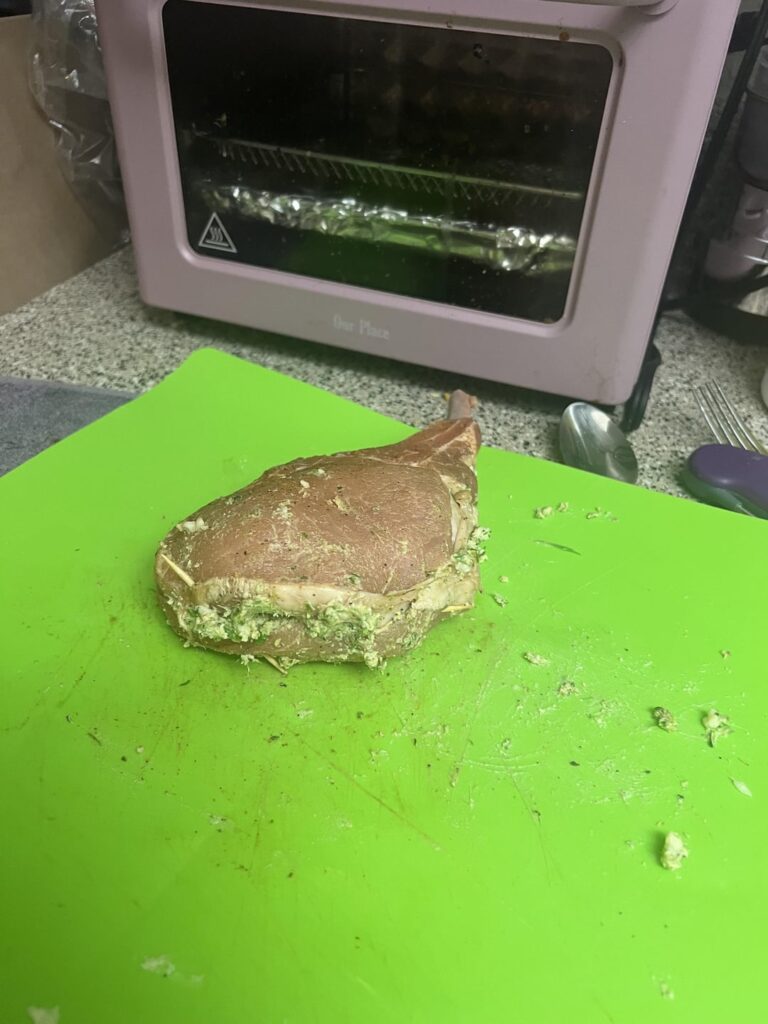 Pork chop stuffed with goat cheese and blanched broccolini