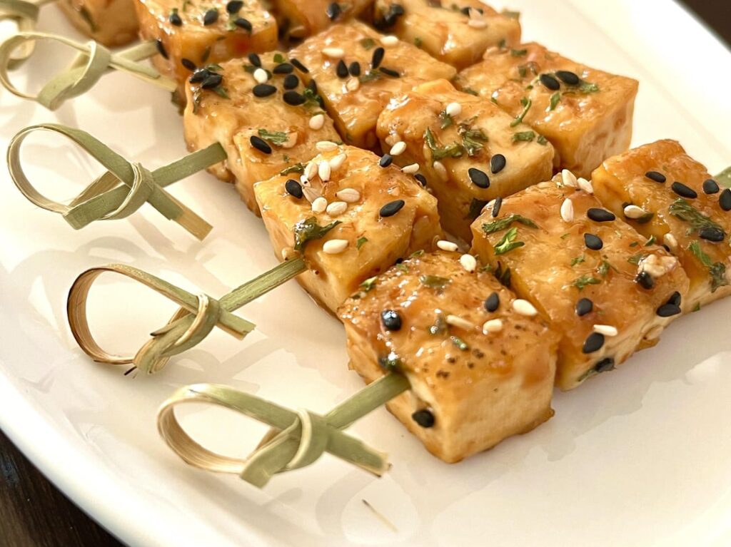Tofu bites with soy, sesame and barbecue sauce glaze.