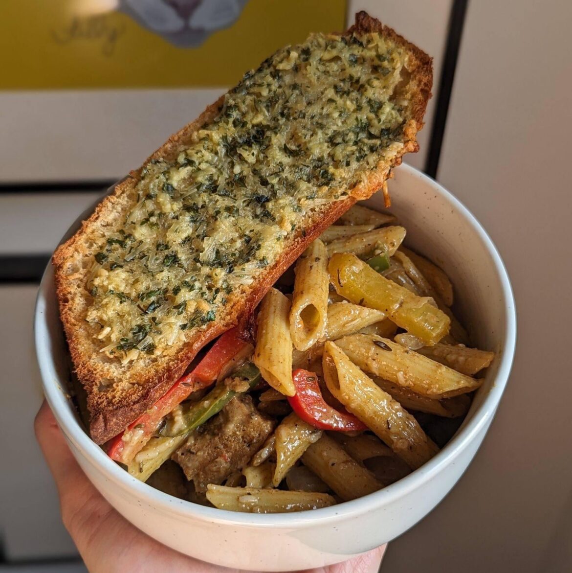 rasta pasta with garlic bread.