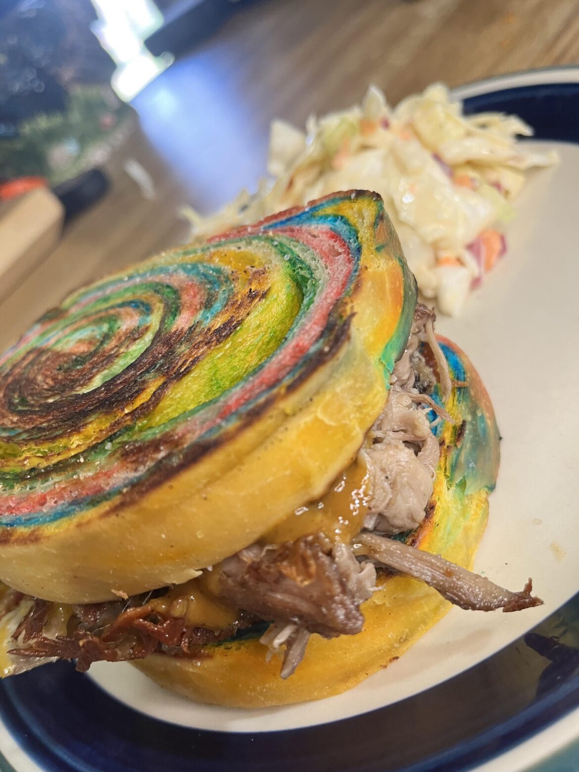 Rainbow sourdough sandwich bread, smoked pulled pork, shredded cheddar, Lillies Q Carolina Gold mustard sauce