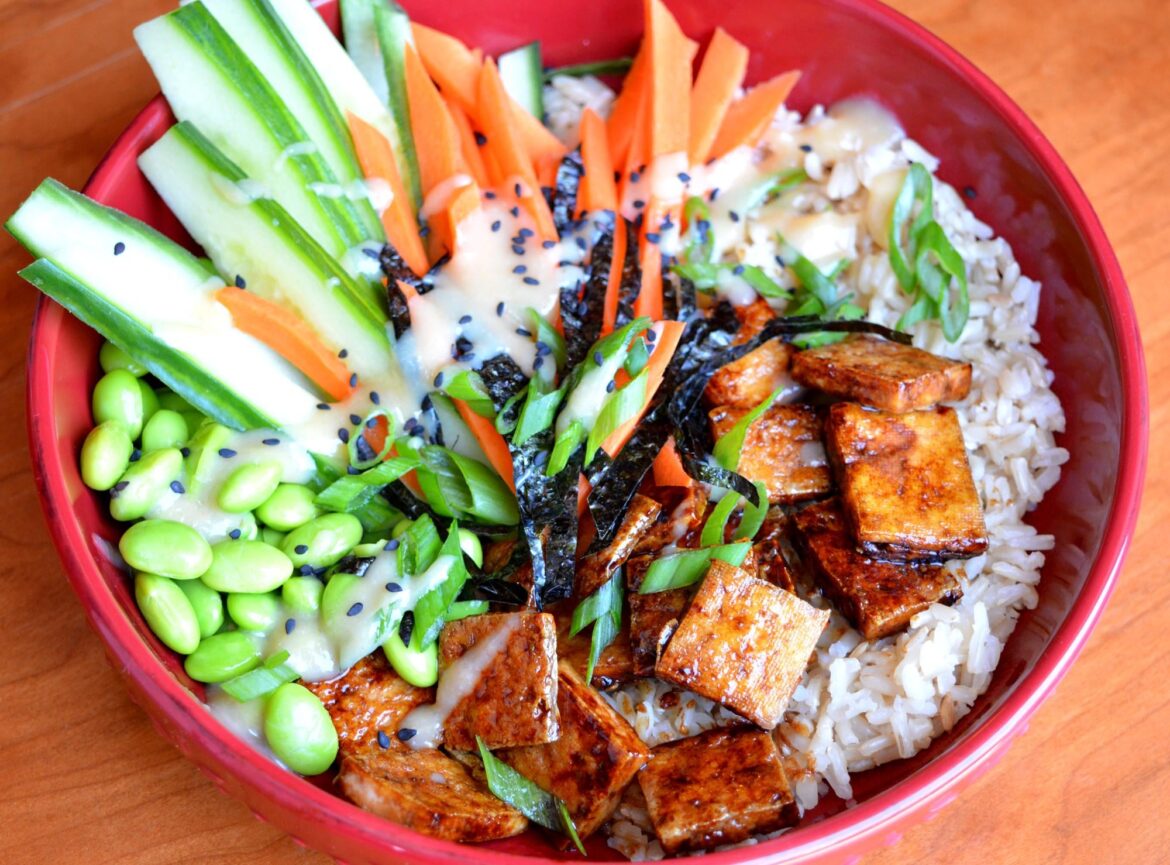 412 cal - Japanese bbq tofu bowl with miso ginger dressing on carrots, cucumbers, edamame and brown rice, topped with roasted seaweed strips