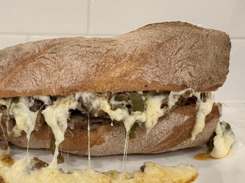Cheesesteak with Gruyère sauce on fresh baguette