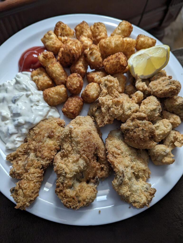 Fried oysters and manilla clams with some tots.
