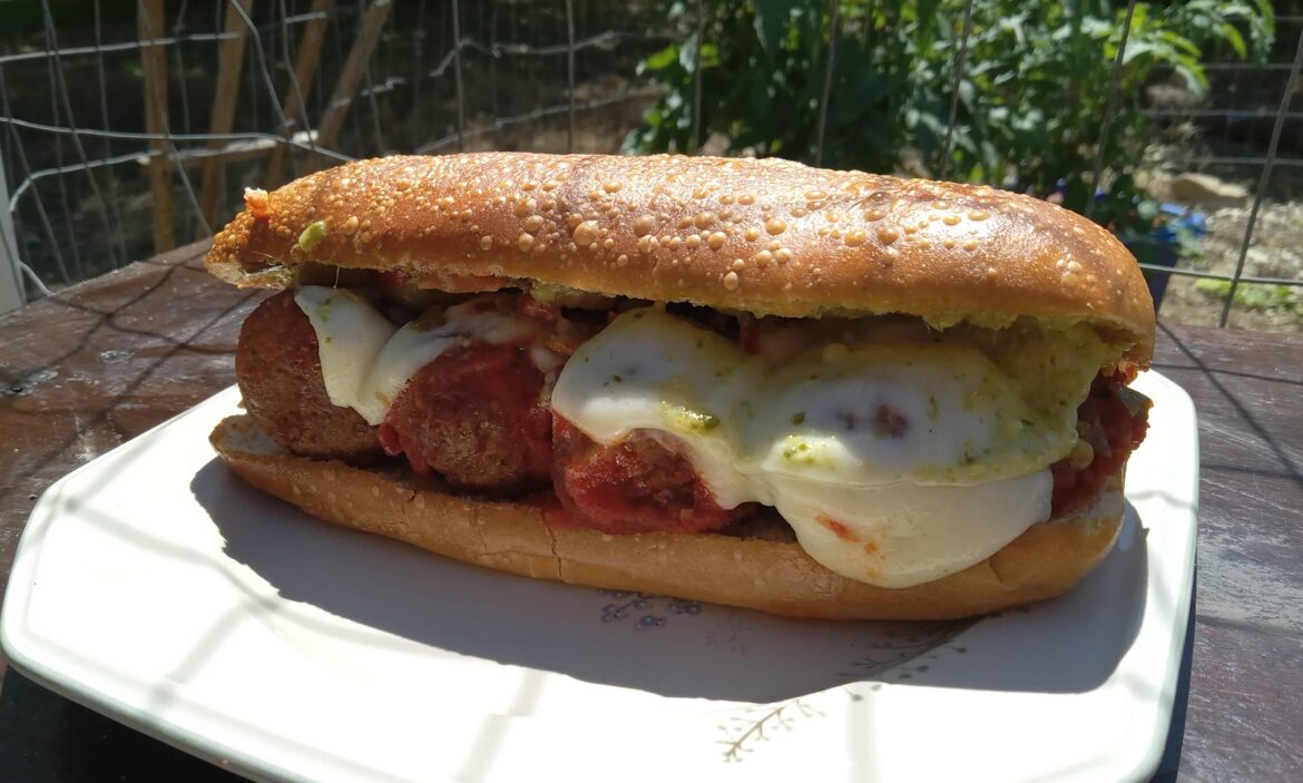 Meatball sub with marinara, provolone, giardiniera, and pesto mayo