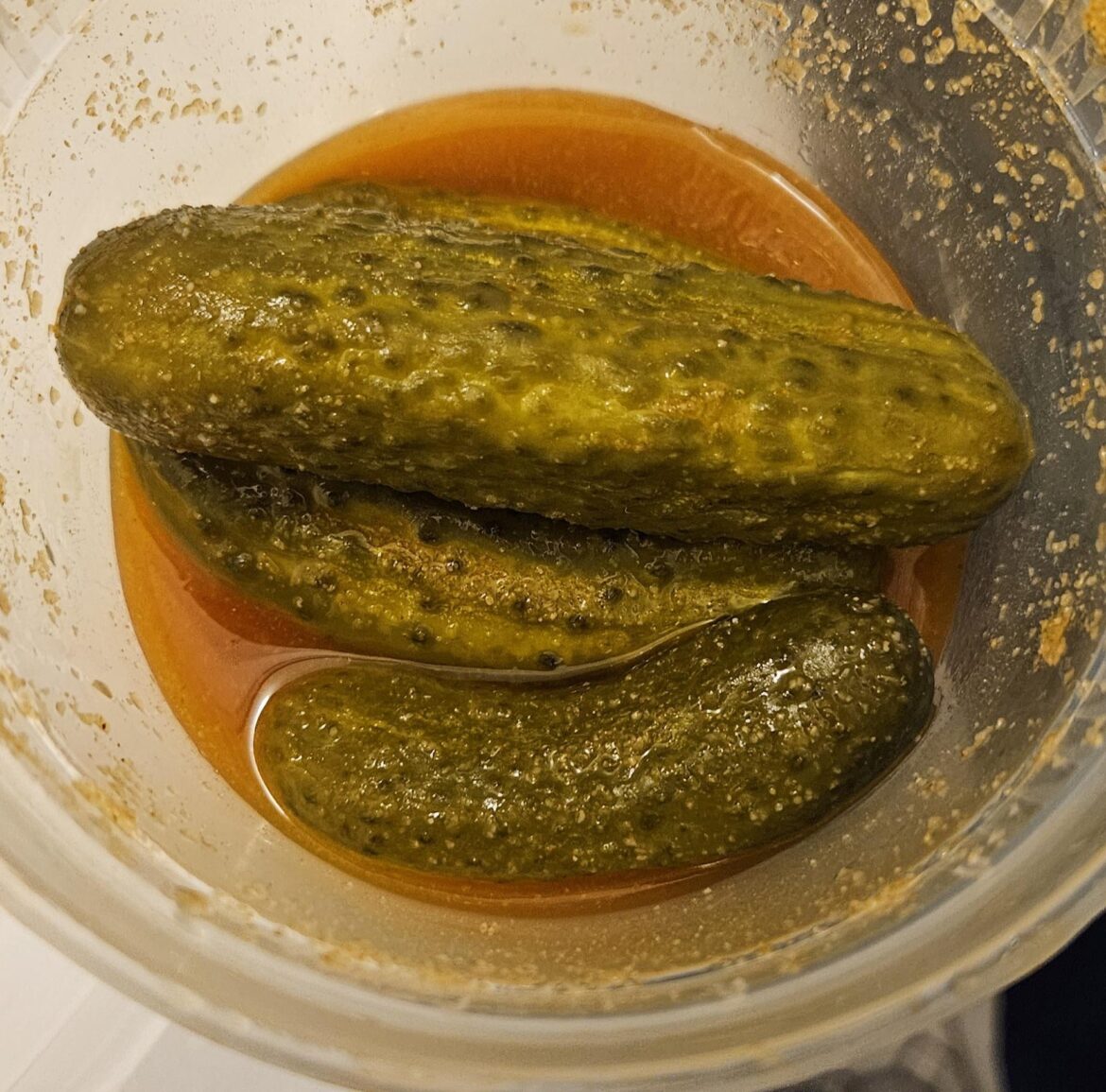 Baby pickles mixed with pickle juice, Louisiana hot sauce, onion powder, garlic powder, salt and cumin powder