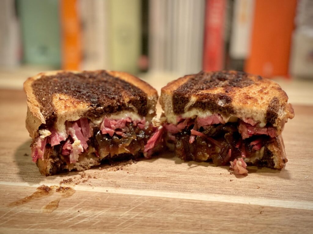 Homemade corned beef with Irish cheddar and Guinness-braised onions on grilled marble rye. I call it a Paddy Melt.