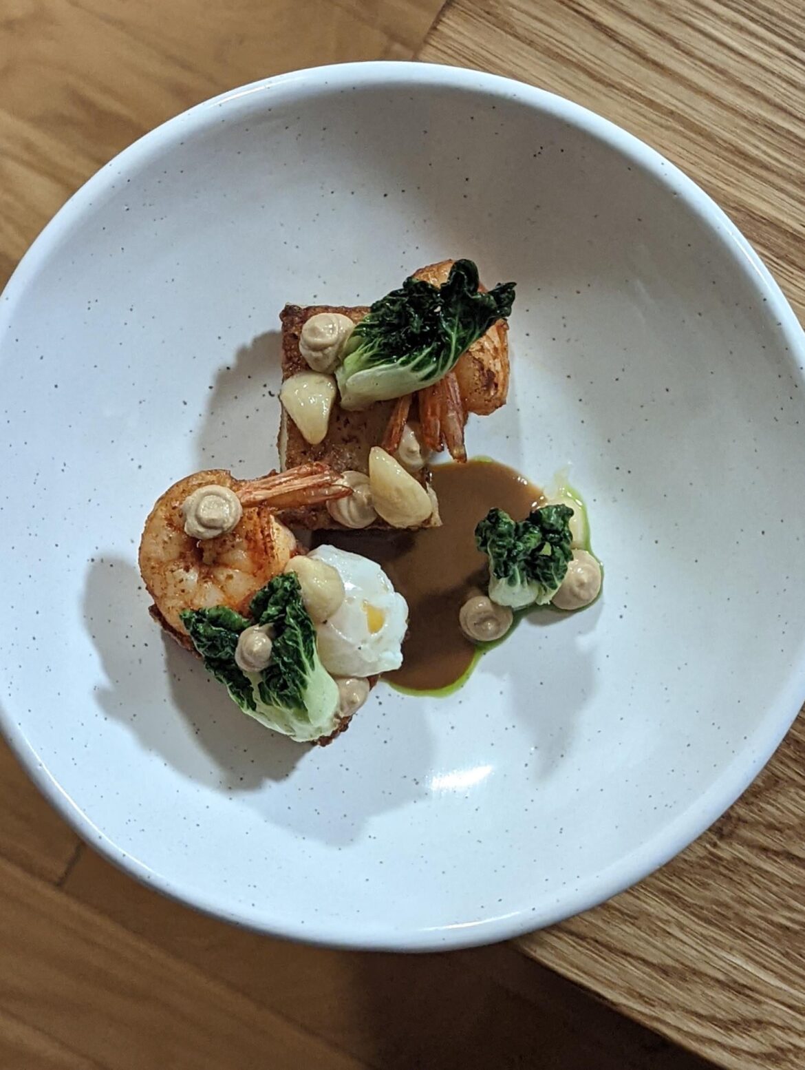 Seared rice noodle presse with shrimp, roasted bok choy, poached quail egg, and confit garlic (inspired by leftover chow fun)