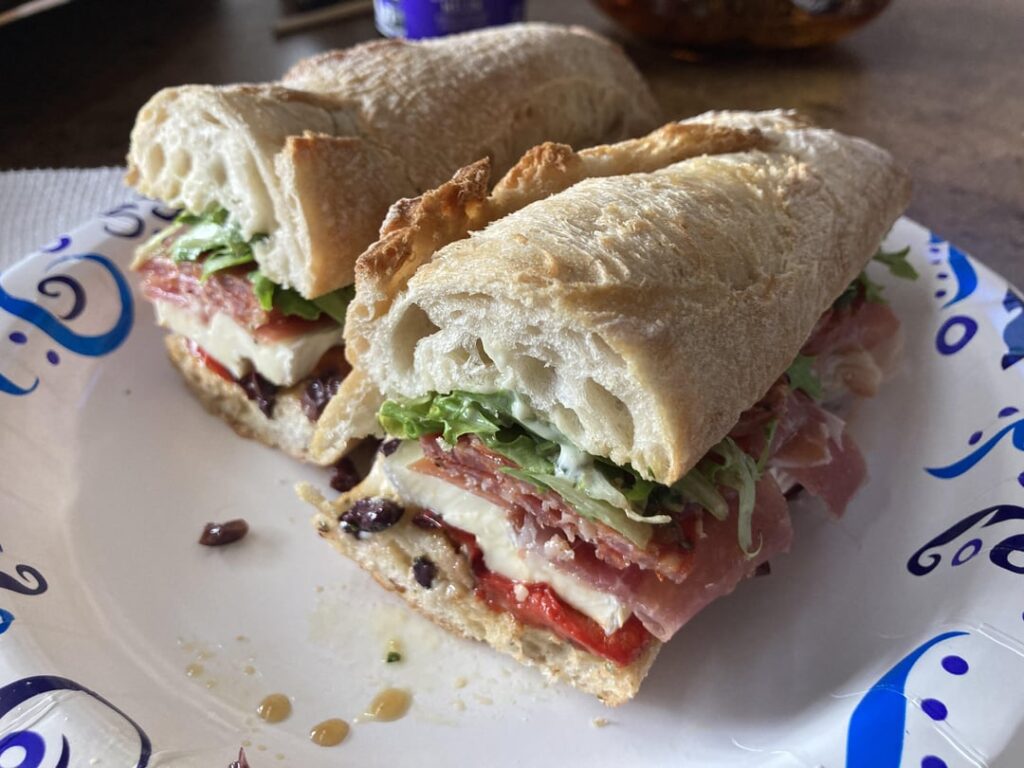 Prosciutto, spicy sopressata , brie, chopped olives, roasted red pepper, arugula, and a fig vinaigrette on buttered baguette halves