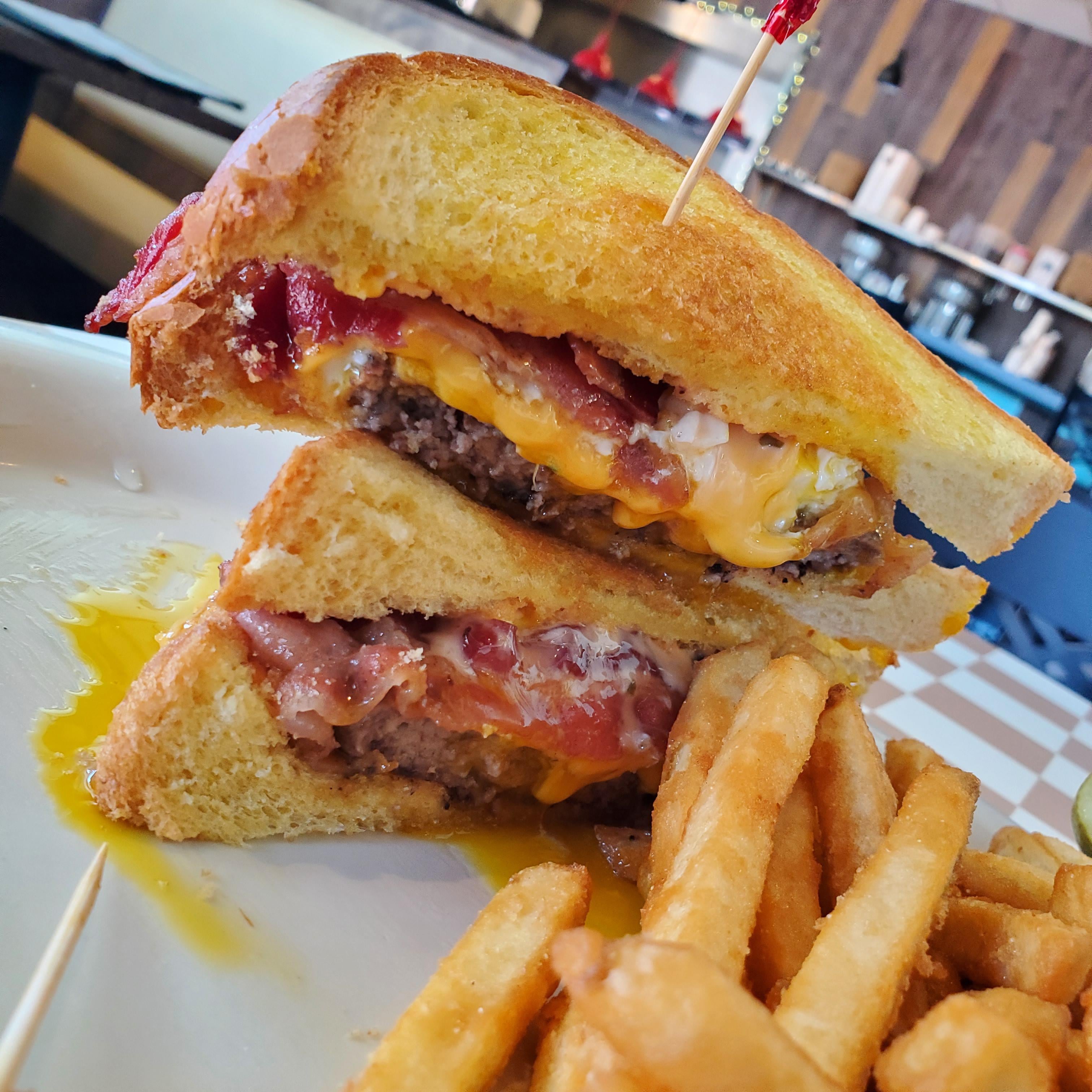 Burger with fried egg, bacon and cheese on buttered toast instead of regular buns Dining and