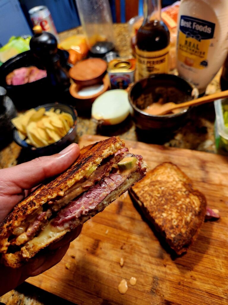 Smoked corned beef on Jewish rye, with melted deli American cheese, and homemade Russian dressing