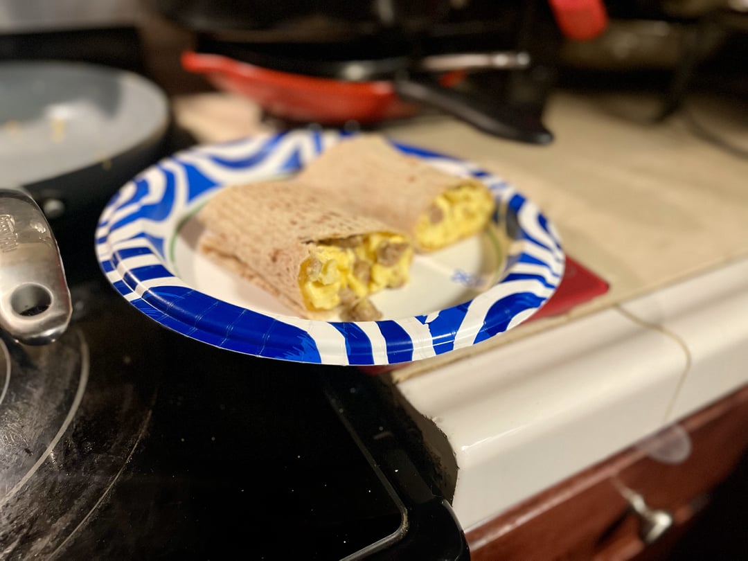 Scrambled eggs, sausage, and gouda on a flaxseed wrapper Dining and