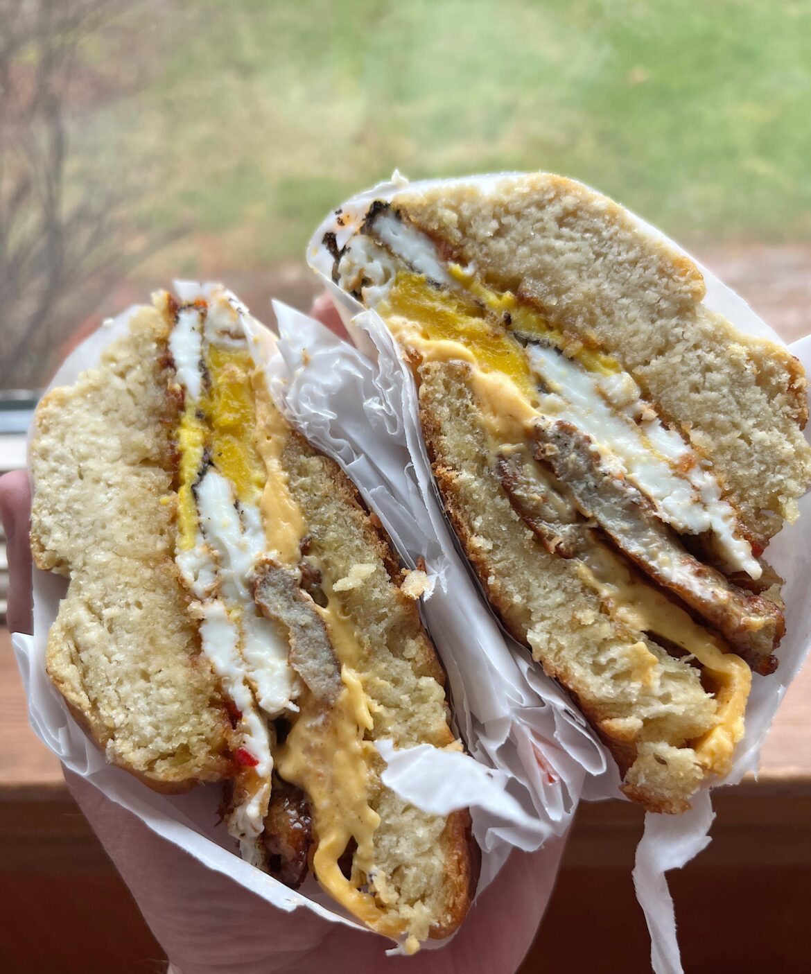 Lopsided but still good structural integrity: maple chicken sausage, hard-fried eggs, gooey American, and pepper-peach jam on a roasted garlic buttermilk biscuit.