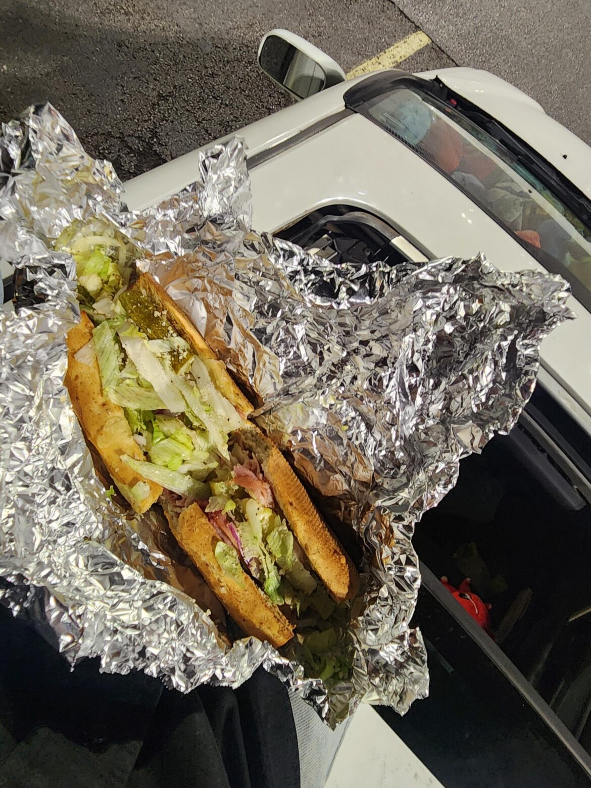 Enjoyin a sub from cheeba hut on my car roof top. (Pikololo, consisting of ham, cheese, pineapple, lettuce, onion, and extra pickle all in a garlic bread loaf.)
