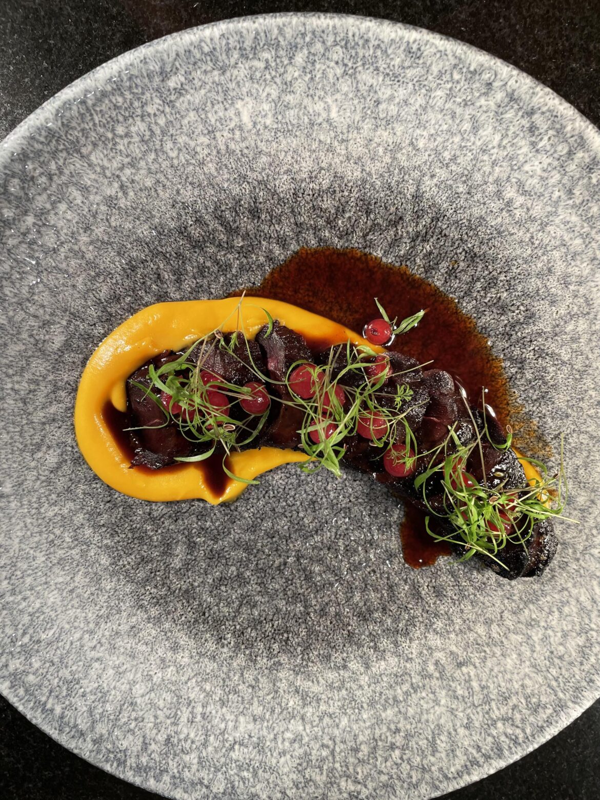Seared honey marinated black bird with truffle sweet potato, pickled wild berries and glaze.