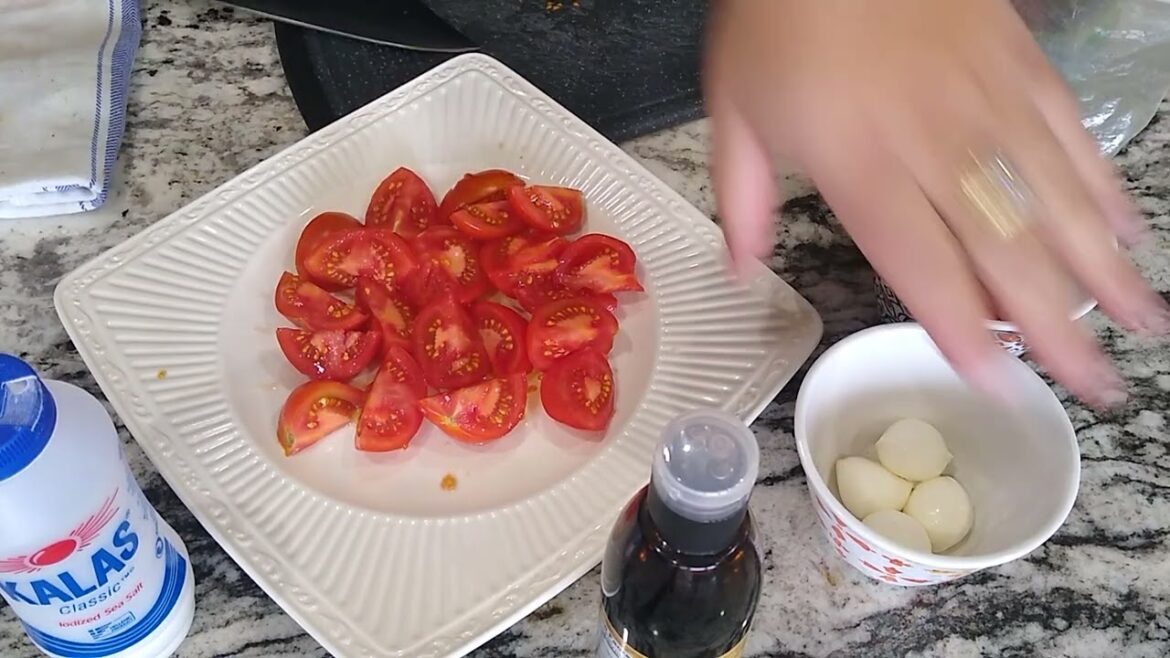 Two minute salad. making a tomato salad with pearl mozzarella cherry tomatoes balsamic vinegar.