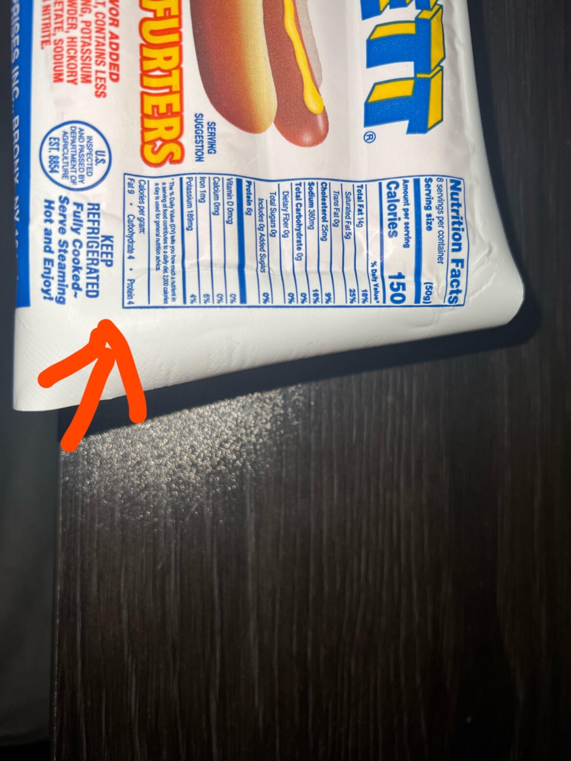 What is the second carb value underneath “calories per gram” on this package of hotdogs?