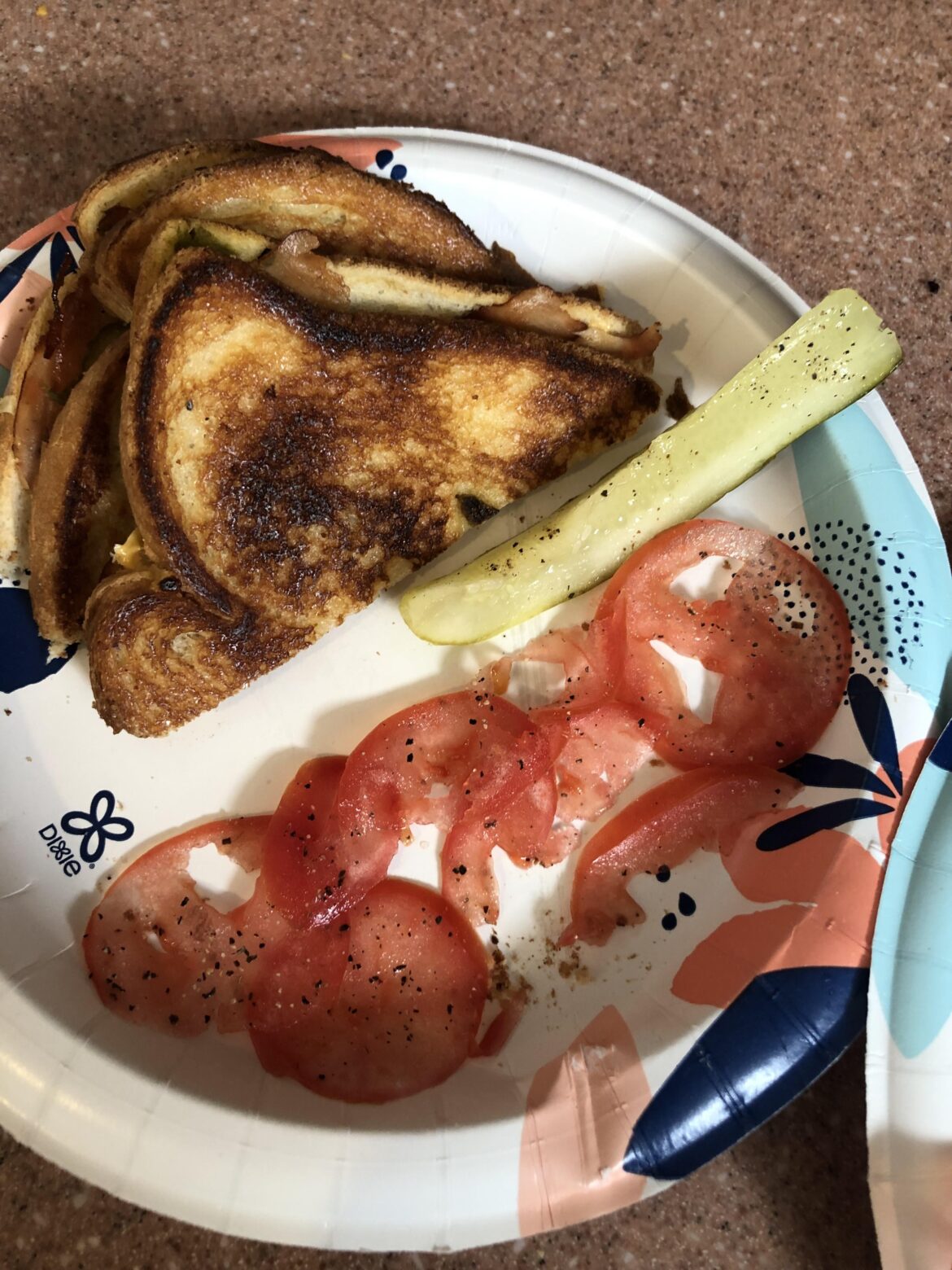 An Albuquerque turkey with a dill slice and seasoned tomato slices