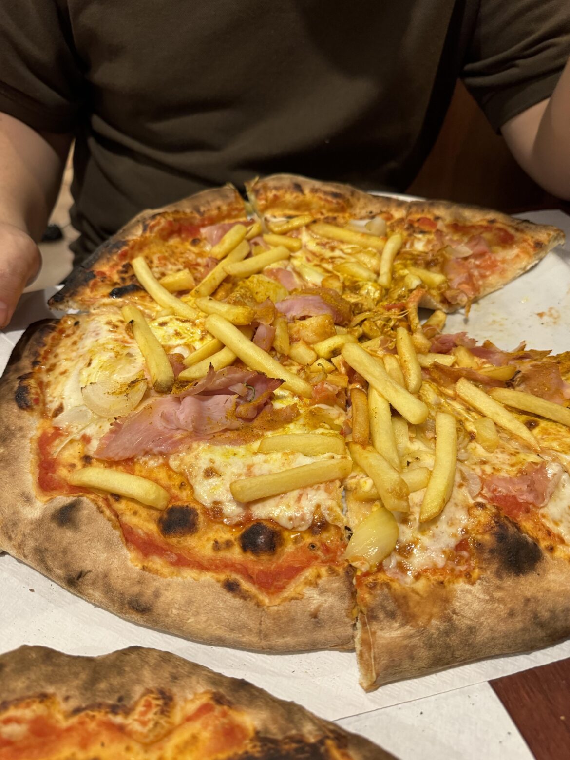 We're italian and my friend got a pizza with curry, ham and french fries