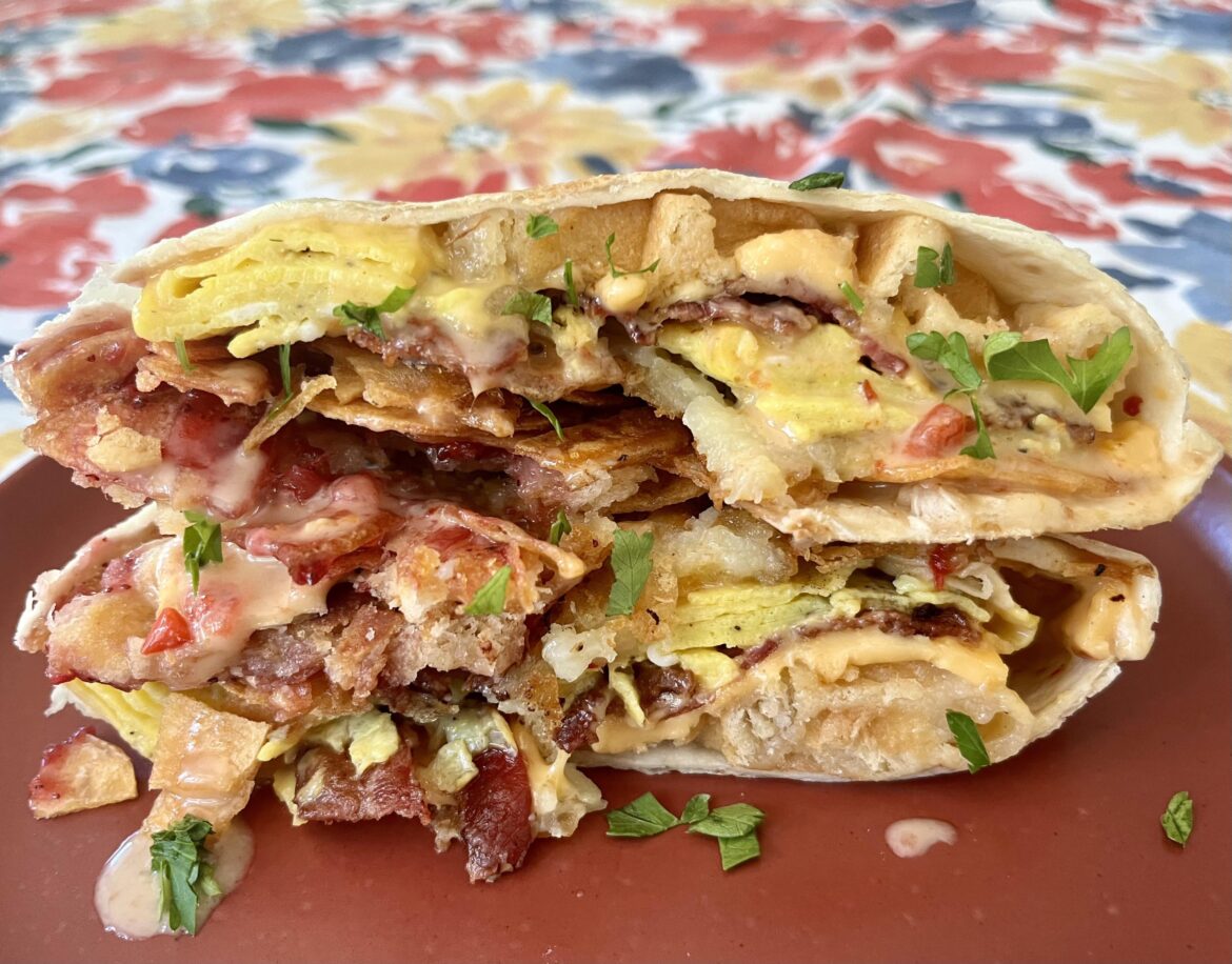 Grab your pitchforks, grab your regular forks: I’m back with a breakfast sandwich crunchwrap: liege waffles sandwiching bacon, scrambled egg, American cheese, lingonberry habanero jam, hash brown, maple breakfast sauce, caramelized onions, and homemade potato chips, wrapped and grilled.