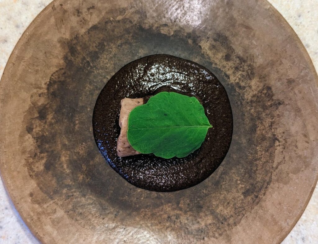 Bean "bellybutton" tamal, almond mole, pápalo.