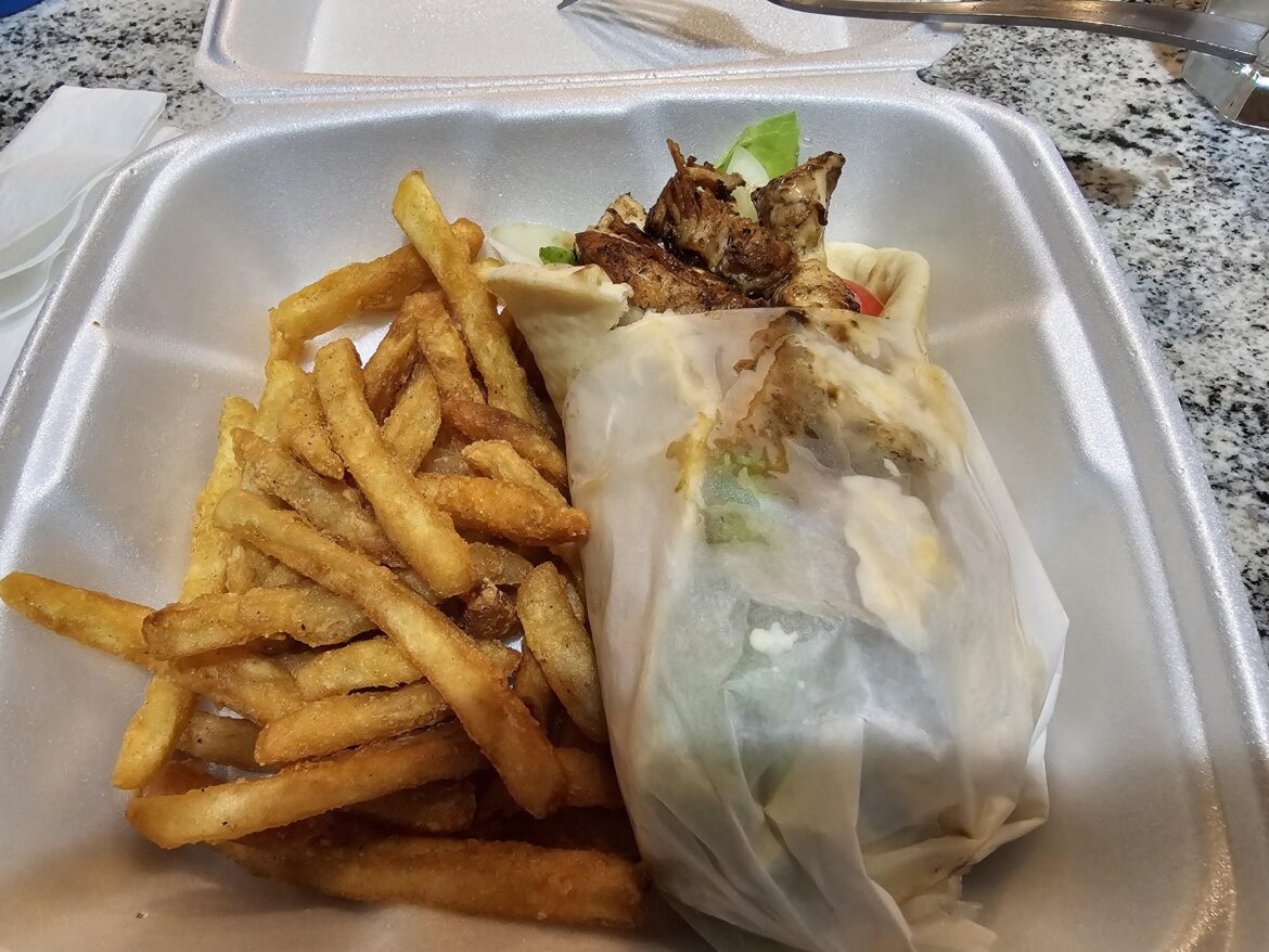 Jerk Chicken Pita wrap with fries.