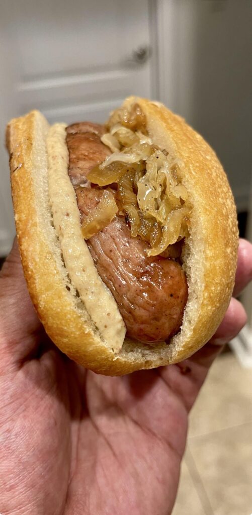 Bratwurst with fried onions, sauerkraut and hot mustard