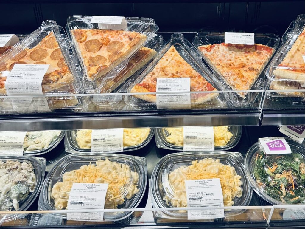 Wegmans. Day old pizza slices with extra plastic.