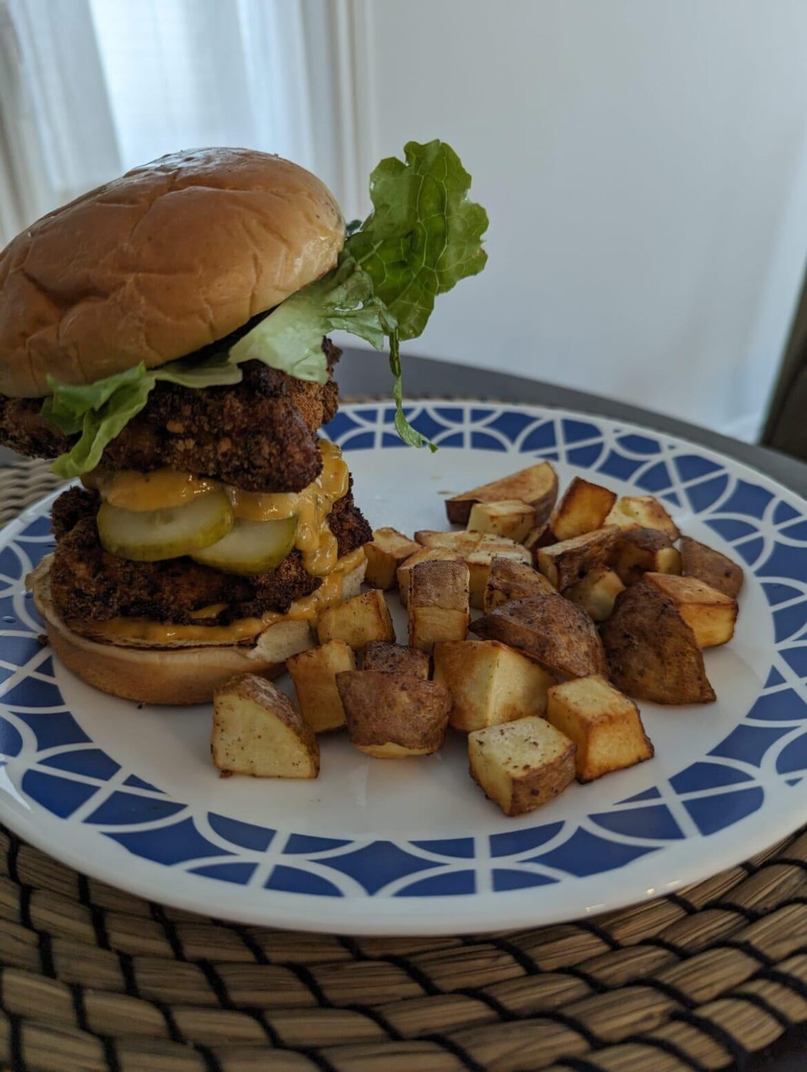 Fried chicken sandwich with roasted potatoes