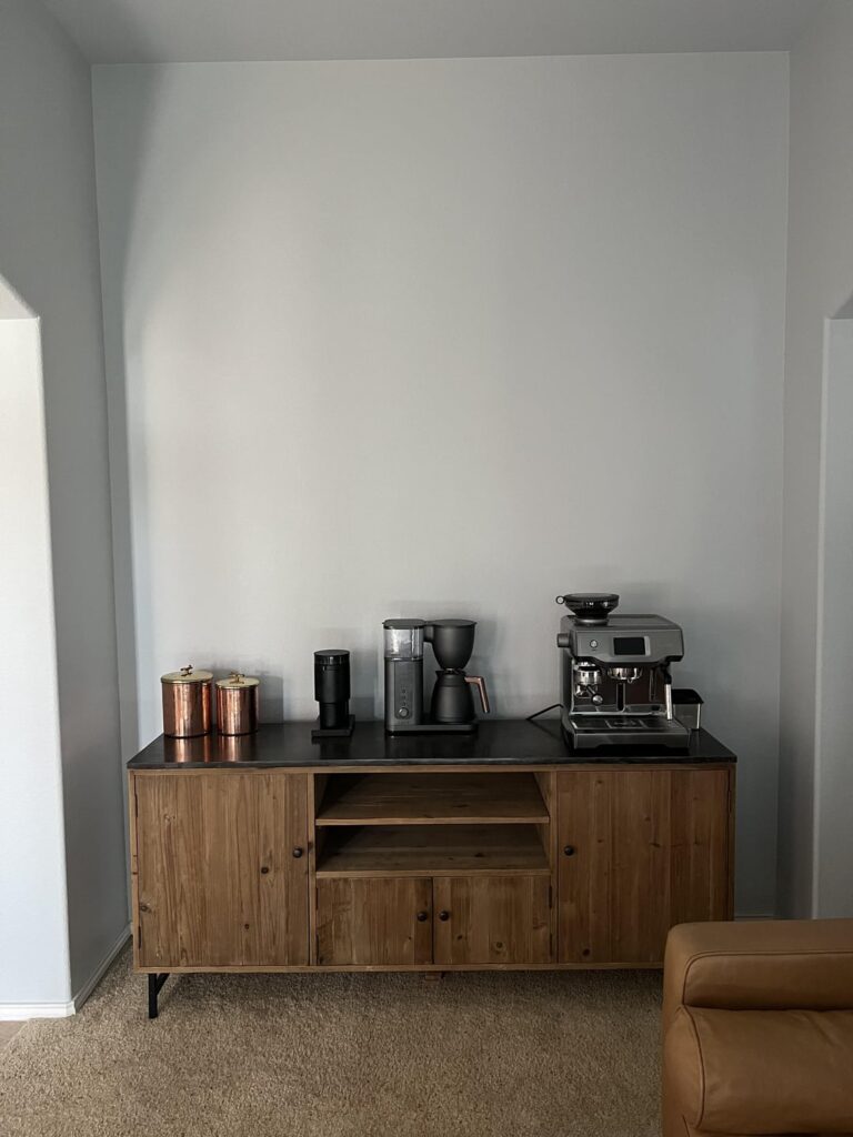 What should I add to the walls/decor to liven up this entry way dining room turned coffee lounge?