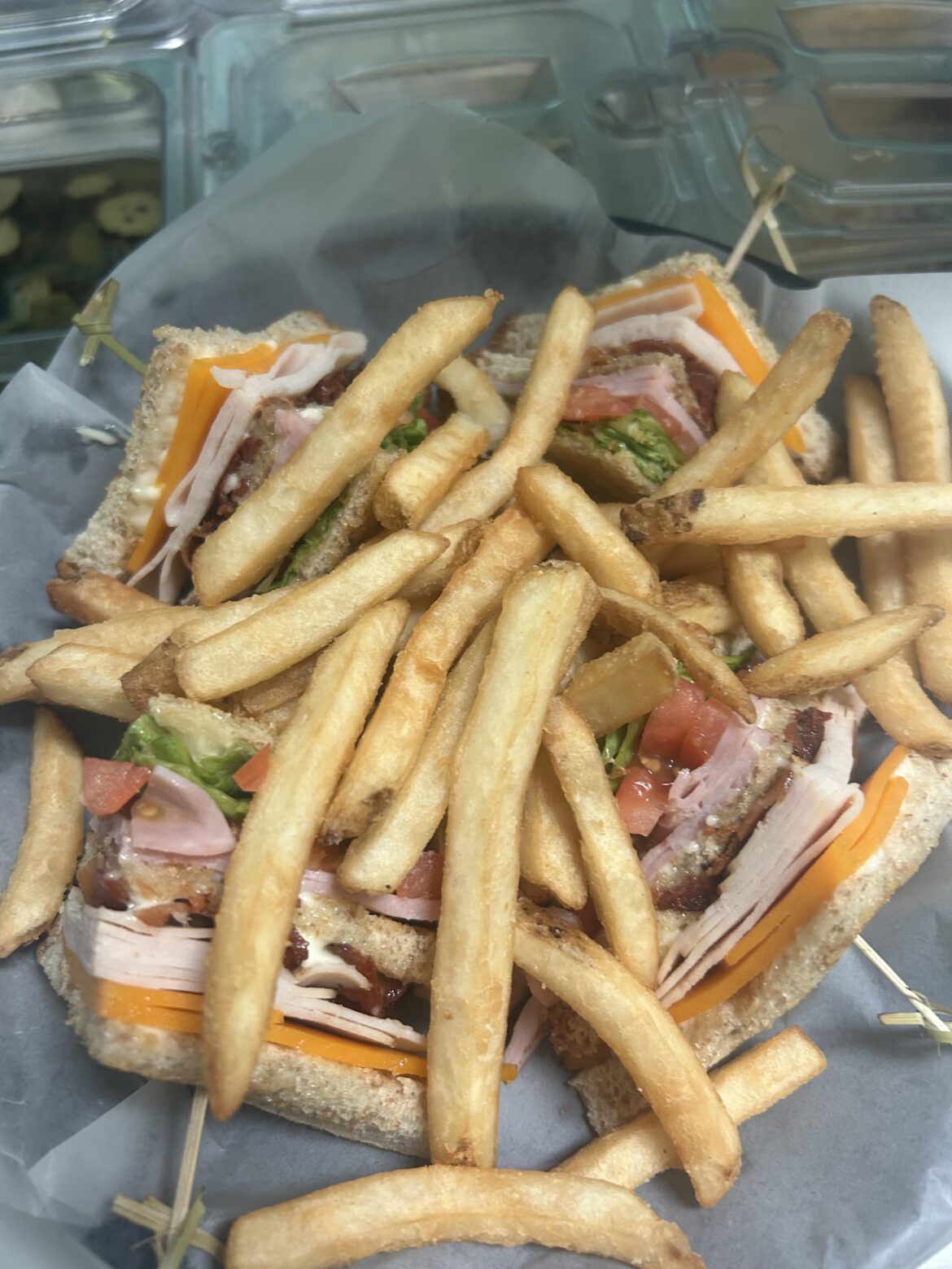 Club Sandwich. Turkey, ham, cheddar, lettuce, tomato, bacon, and mayo