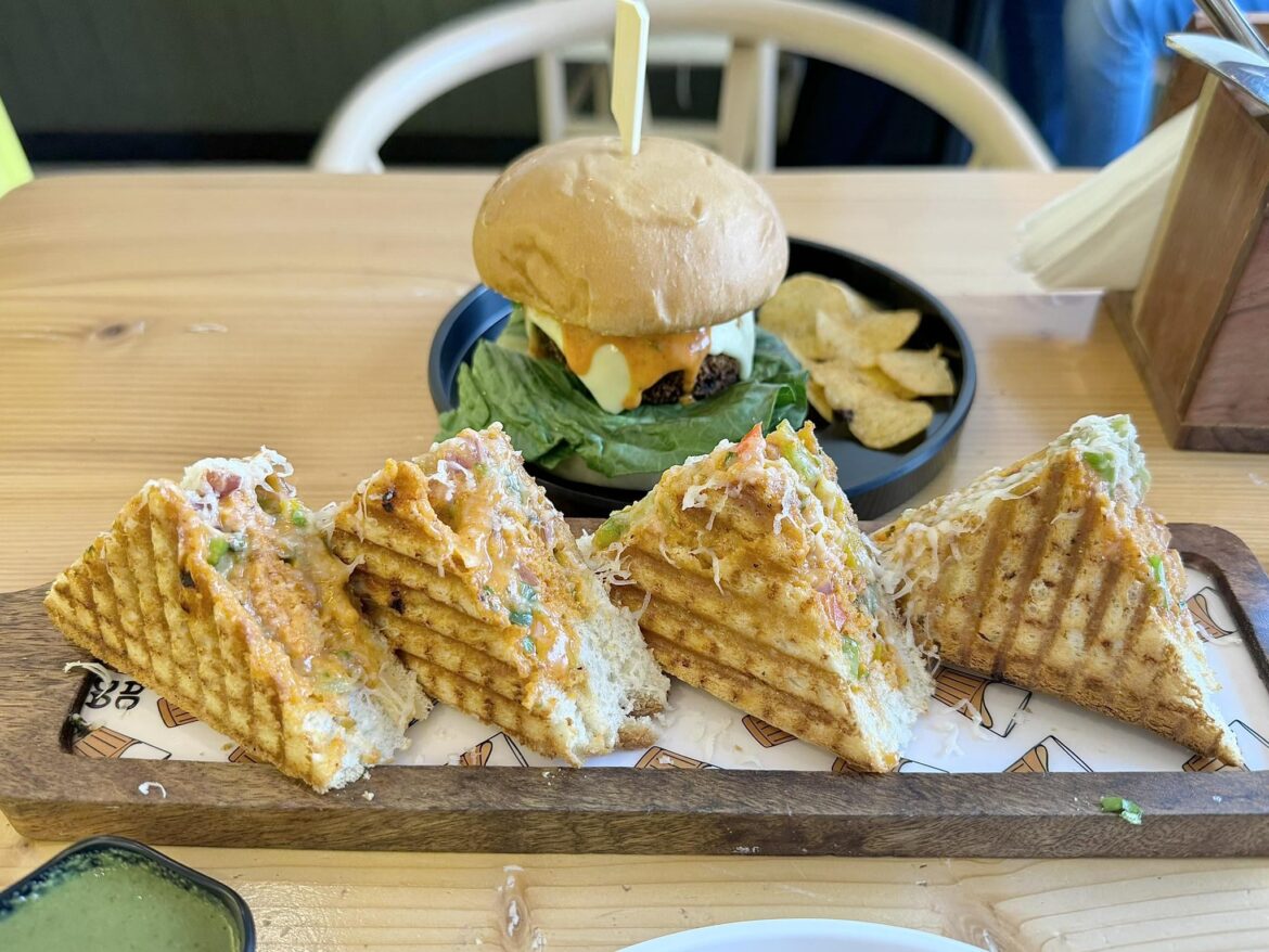 Veggie Grilled Sandwich from Local Cafe (w/ Veggie Patty Burger in the Back)