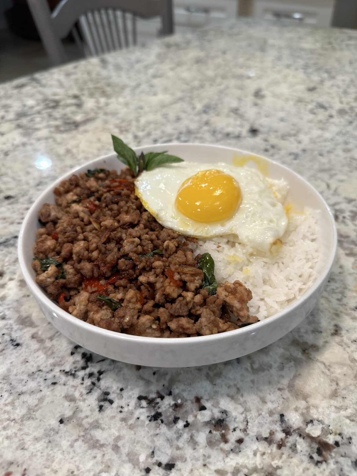 Stir fried pork with Thai chilis and Thai holy basil. Always served with a fried egg on top! Called “Pad Gra Prow” in Thai!