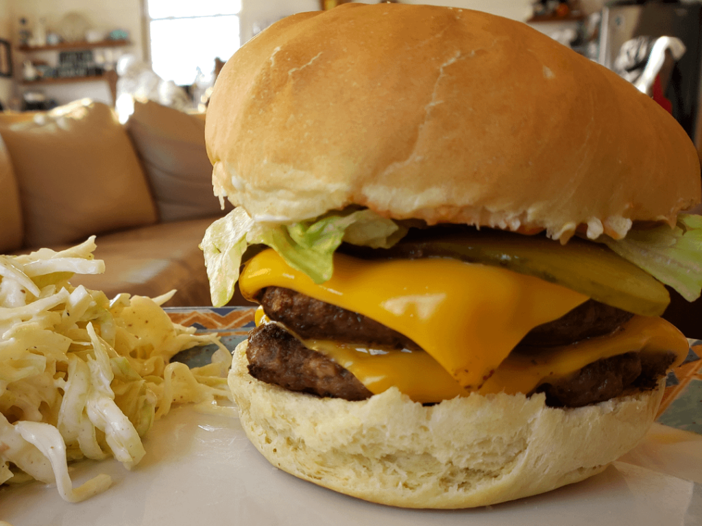 Double cheeseburger with homemade coleslaw and a homemade bun.