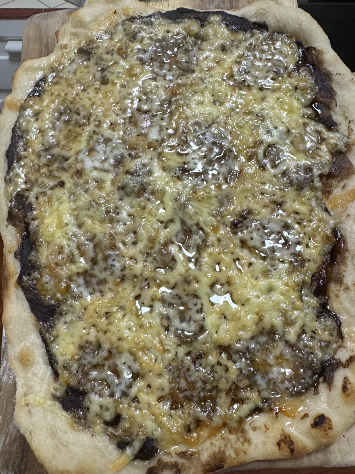 A wet mozzarella and mushroom sauce pizza.