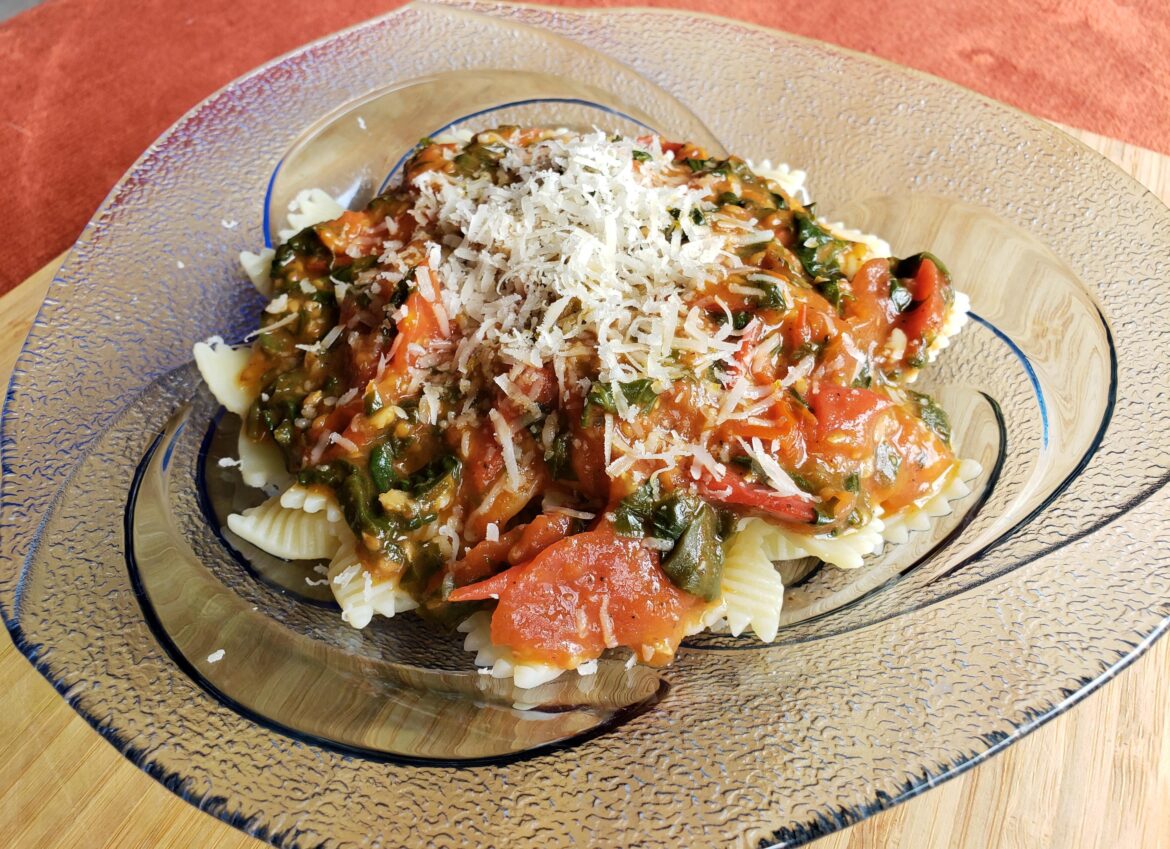 Homemade chunky cherry tomato and spinach pasta