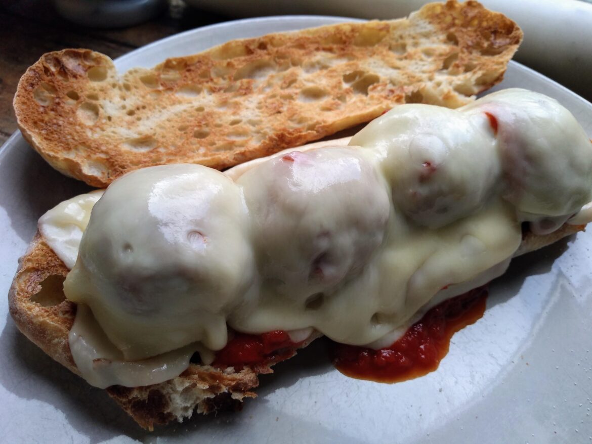 Meatballs on ciabatta with Emmental and herby tomato sauce