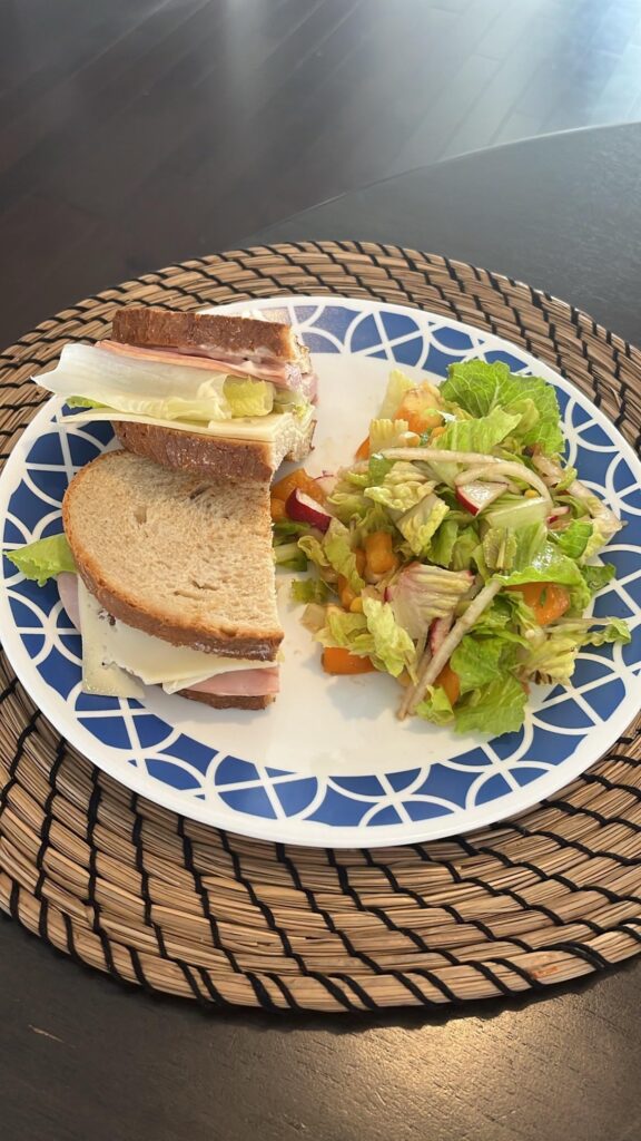 Ham, lettuce & Swiss cheese sandwich with salad